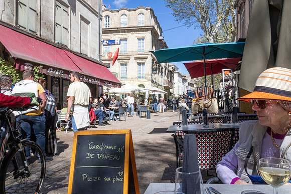 Arles sidewalks on Feria festival day. (Nancy at our pizza shop)